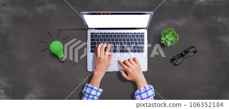 Green light bulb with a laptop computer 106352184
