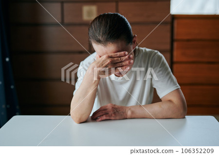 Senior woman holding head 106352209