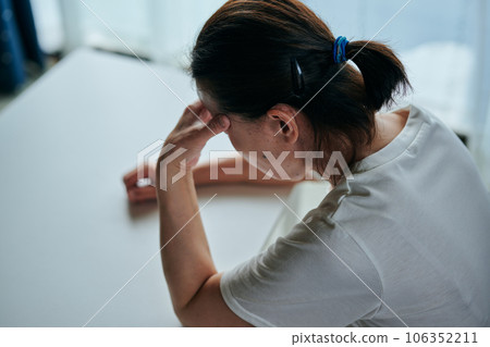 Senior woman holding head 106352211