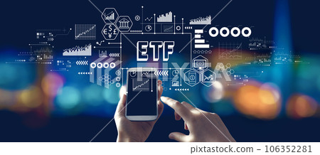 ETF theme with person using a smartphone at night 106352281