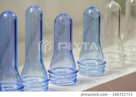 Close up scene of group of preform shape of PET bottle products. 106352751