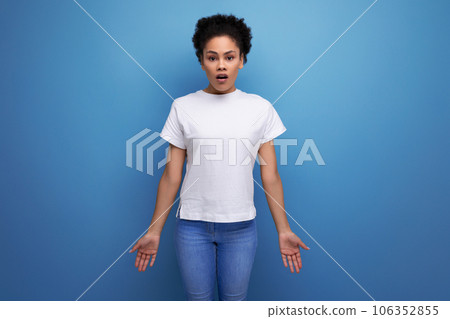 close-up of a young swarthy woman with fluffy curly hair dressed in a white T-shirt close-up of a young swarthy woman with fluffy curly hair dressed in a white T-shirt 106352855