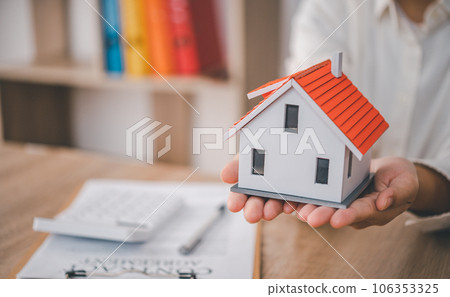 Salesperson Holding house keys concept, house keys for new house, new house purchase. Salesperson Holding house keys concept, house keys for new house, new house purchase. 106353325
