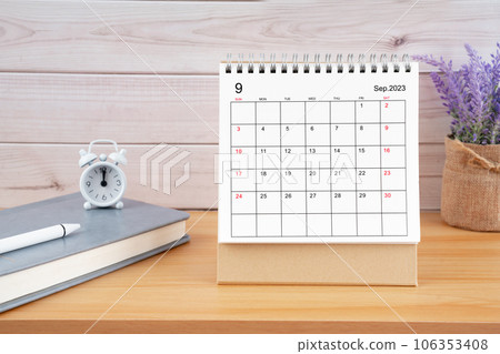 The October Monthly desk calendar for 2023 year and diary on wooden table. The October Monthly desk calendar for 2023 year and diary on wooden table. 106353408