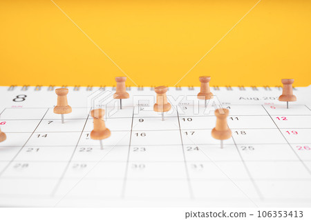 The wooden pin on the calendar indicates the schedule with yellow background, Planning concept. 106353413