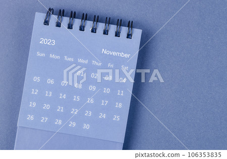 The November 2023 Monthly desk calendar for 2023 year on blue background. 106353835