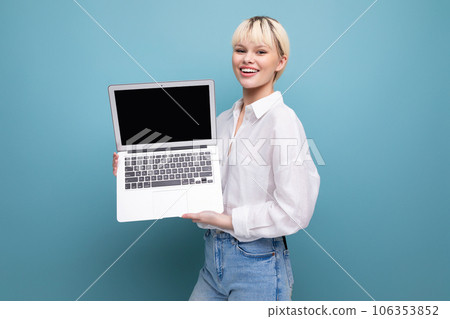 young successful blond student woman dressed in a white blouse demonstrates a project on a laptop young successful blond student woman dressed in a white blouse demonstrates a project on a laptop 106353852