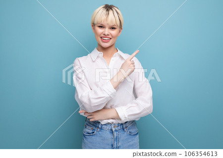 young caucasian woman with a short haircut is dressed in a white shirt on a blue background with 106354613