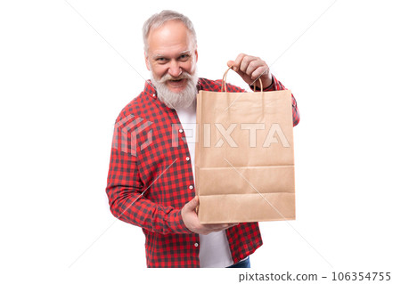 middle age business. handsome mature gray-haired man with a beard holding a shopping bag 106354755