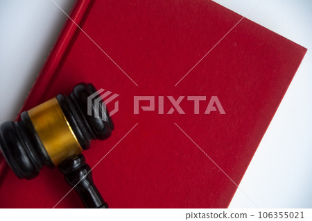 Top view of empty cover red book with gavel. Copy space. Top view of empty cover red book with gavel. Copy space. 106355021