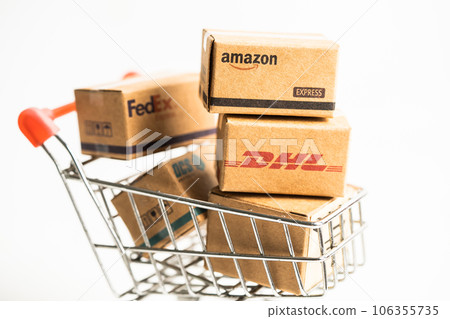 Bangkok, Thailand September 26, 2022 Shopping cart with DHL Amazon and FedEx express packing box, import export online exchange investment business. 106355735