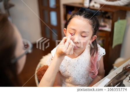 Girl learning makeup from mother Girl learning makeup from mother 106355774