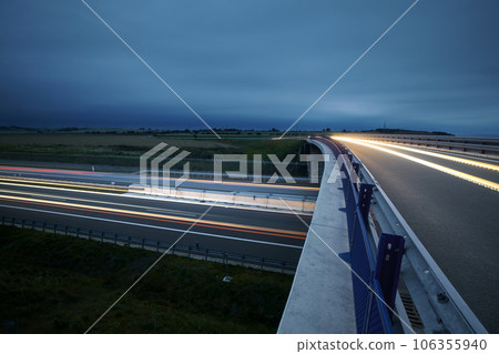 Road overpass over multiple lane highway in countryside 106355940