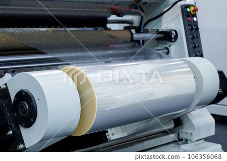 roll of plastic packaging film on the automatic packing machine in food product factory. industrial and technology concept. 106356068