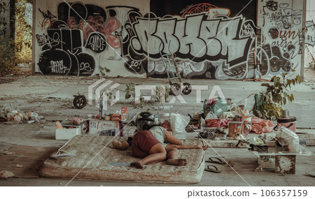 Homeless girl is sleeping in the abandoned building 106357159