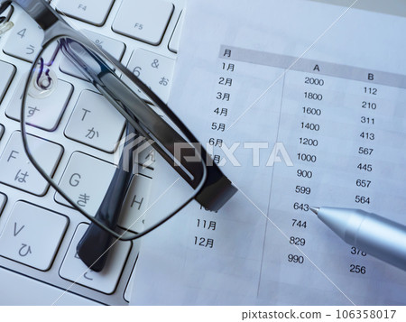 Documents, glasses and keyboard on the table Documents, glasses and keyboard on the table 106358017