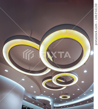 Hanging rounded ceiling mounted light fixtures with modern LED light bulb. 106358130