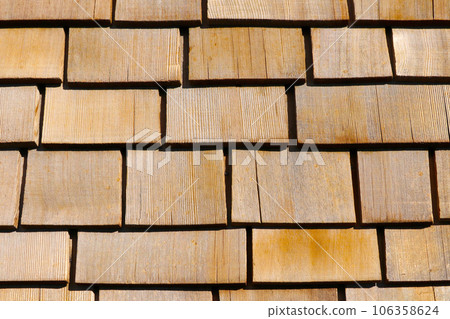 Wooden background on the roof of the house. Wood texture. Wooden background on the roof of the house. Wood texture. 106358624