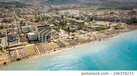 Golem, Durres, Albania - 22 august 2023: Aerial view to sandy beach full of umbrellas and people in summer season 2023 106359215