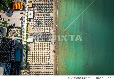 Golem, Durres, Albania - 22 august 2023: Aerial view to sandy beach full of umbrellas and people in summer season 2023 106359266