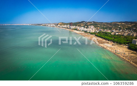 Golem, Durres, Albania - 22 august 2023: Aerial view to sandy beach full of umbrellas and people in summer season 2023 106359286