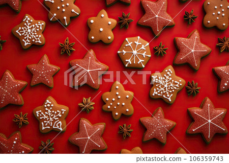 Christmas gingerbread cookies on red background. Top view Christmas gingerbread cookies on red background. Top view 106359743