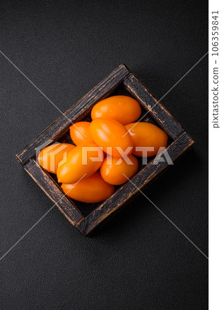 Bright juicy fresh yellow plum-shaped tomatoes. Preparing the tomato sauce 106359841