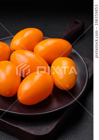 Bright juicy fresh yellow plum-shaped tomatoes. Preparing the tomato sauce 106359853