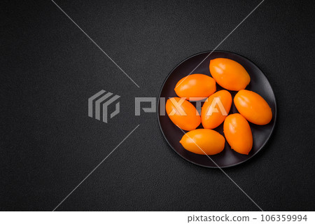 Bright juicy fresh yellow plum-shaped tomatoes 106359994