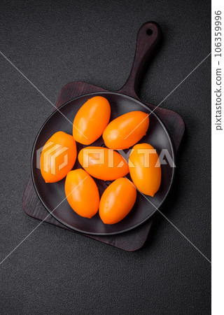 Bright juicy fresh yellow plum-shaped tomatoes Bright juicy fresh yellow plum-shaped tomatoes 106359996