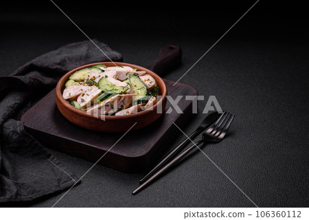 Delicious juicy fresh salad of cucumbers and grilled chicken slices, with french mustard 106360112