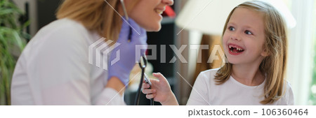 A happy little girl in a clinic of a doctor, a close-up A happy little girl in a clinic of a doctor, a close-up 106360464