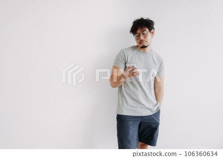 Bored face man using mobile phone app boringly isolated on white. 106360634