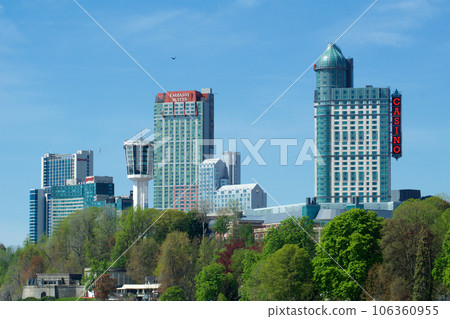 NIAGARA FALLS, ONTARIO, CANADA - MAY 21st 2018: Exterior view of the Fallsview Casino Resort tower and skyline in Niagara Falls during spring NIAGARA FALLS, ONTARIO, CANADA - MAY 21st 2018: Exterior view of the Fallsview Casino Resort tower and skyline in Niagara Falls during spring 106360955