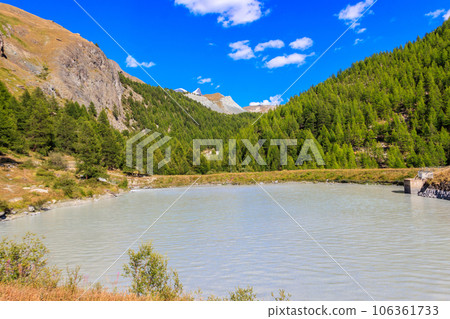 View of Moosjisee lake and the Swiss Alps at summer on the Five Lakes Trail in Zermatt, Switzerland View of Moosjisee lake and the Swiss Alps at summer on the Five Lakes Trail in Zermatt, Switzerland 106361733