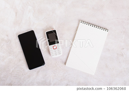 Alternative between modern smartphone, feature phone and notepad top view 106362068