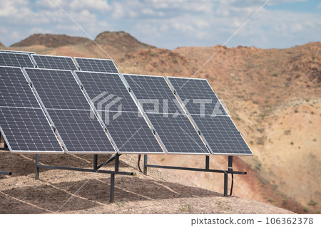 Solar panels in a hard-to-reach arid mountainous area, alternative electricity source - concept of sustainable resources Solar panels in a hard-to-reach arid mountainous area, alternative electricity source - concept of sustainable resources 106362378