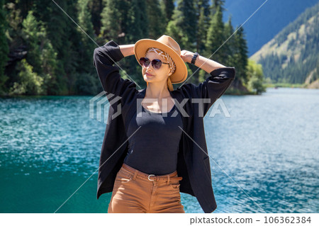 Happy woman on Kolsay mountain lake in Kolsai Koldery gorge, nature of Kazakhstan National Park Happy woman on Kolsay mountain lake in Kolsai Koldery gorge, nature of Kazakhstan National Park 106362384