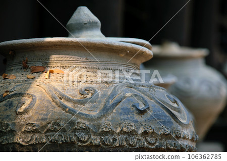 Old Thai traditional stone vase on outdoors ground. Old Thai traditional stone vase on outdoors ground. 106362785