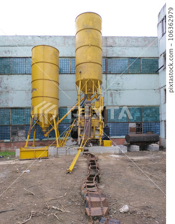 two large yellow containers in an industrial plant two large yellow containers in an industrial plant 106362979