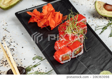 Traditional delicious fresh sushi roll set. Sushi roll with rice, nori, cream cheese, tobiko caviar, avocado. Sushi menu. 106363098