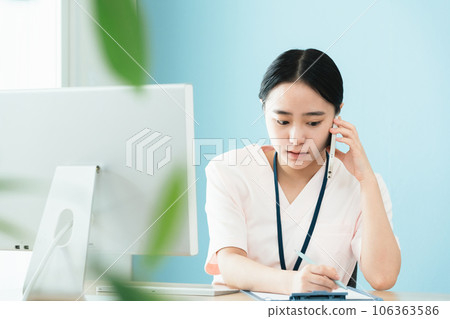 Medical staff woman confirming by phone 106363586