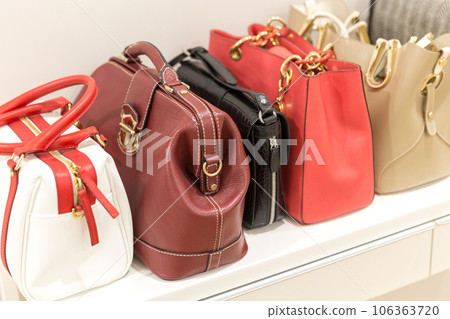Collection of handbags standing in a row 106363720