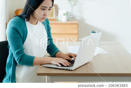 A young woman working on a laptop A young woman working on a laptop 106363865