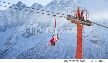People are lifting on open lft high up in Caucasus mountains People are lifting on open lft high up in Caucasus mountains 106364022