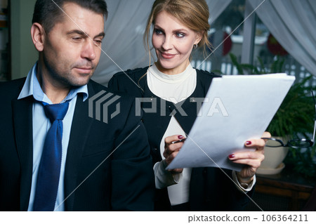 Happy Mature Businessman And Businesswoman working with documents 106364211