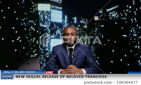 Presenter announcing new movie premiere on late night talk show, discussing about famous film franchise on live television program. African american host presenting world news. 106364877