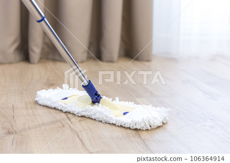 Modern white mop cleaning a wooden floor Modern white mop cleaning a wooden floor 106364914