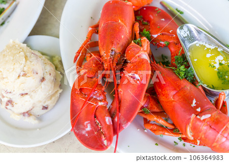 Lobster dinner with potato salad and butter 106364983