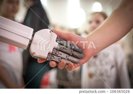 Man and robot shaking hands. Concept of human interaction with artificial intelligence 106365026